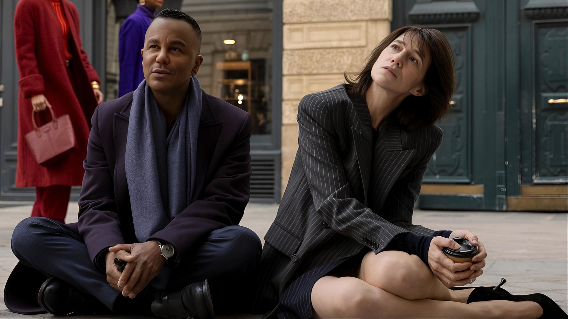 Geneviève Lavigne, played by Charlotte Gainsbourg, and Raphaël Marchand, portrayed by Yanic Truesdale, share a quiet moment outside the ballet academy in Paris. (Image via Amazon Prime)